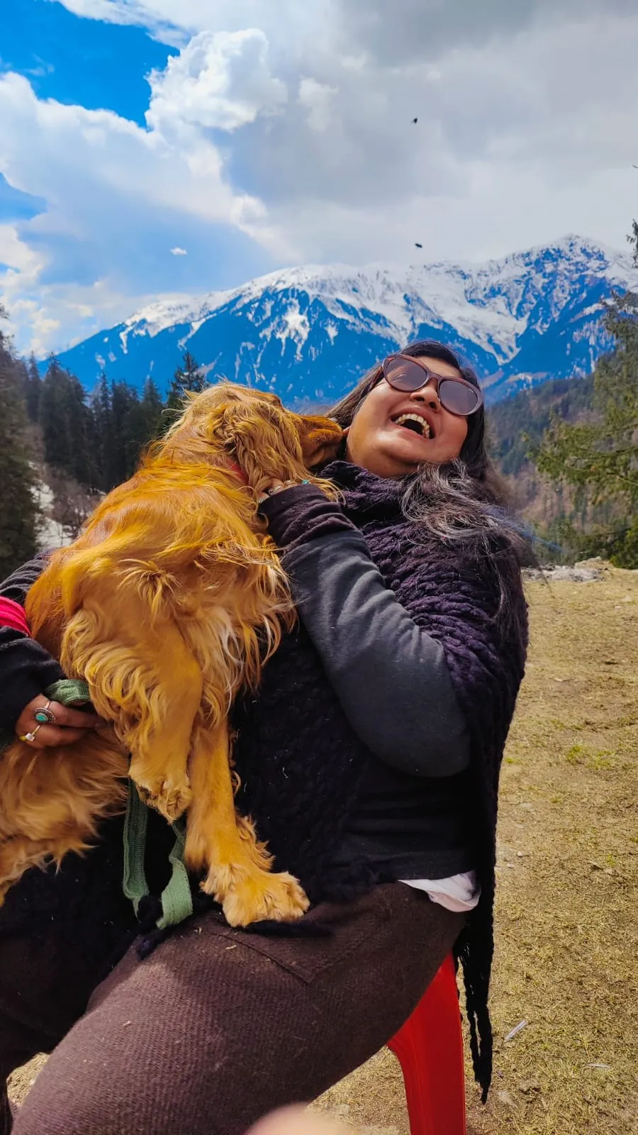 Mugdha holding Simba in the mountains